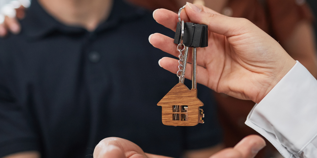 couple buying a house A couple taking the keys to their new house after an accepted mortgage offer using the Property Conveyancing Fees Calculator.