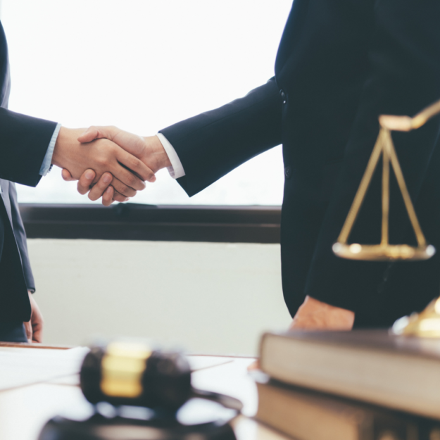 Right solicitor A person meeting the right solicitor for them and shaking hands.