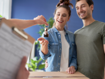 An unmarried couple collecting the key to their new house.