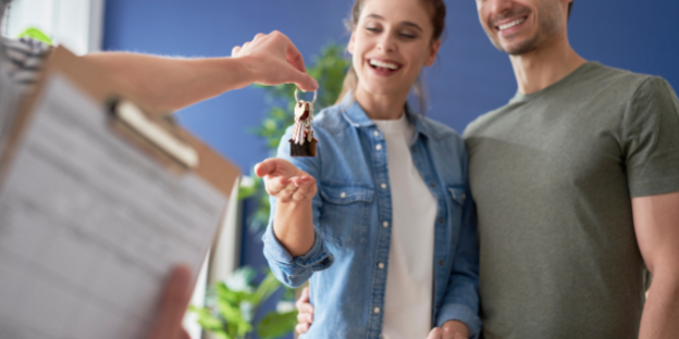 An unmarried couple collecting the key to their new house.