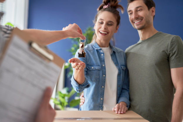 An unmarried couple collecting the key to their new house.