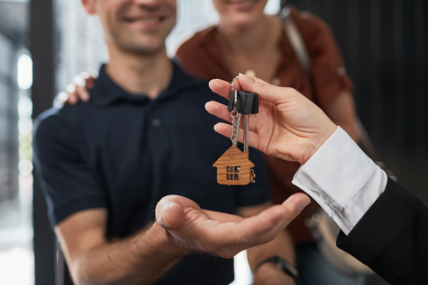 Proof of Funds for Conveyancing A smiling couple receiving keys to their new home after completing proof of funds, symbolising a successful property purchase.