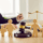 Wooden family figures with a gavel and scales of justice in the background, symbolising child court applications and family law.