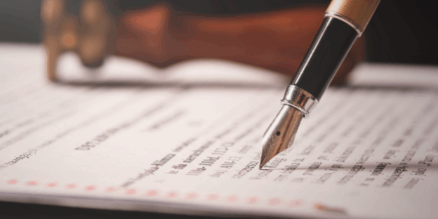 Why making a Will is important – signing a legal Will document with a pen, PHH Solicitors
