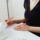 Woman in black reviewing signed Lasting Power of Attorney document at desk before sending to the Office of the Public Guardian.